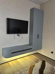 a living room with a flat screen tv on a wall at Квартира ЖК Кербез in Aktau