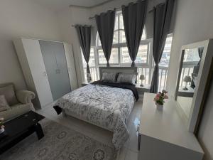 a bedroom with a bed and a window at Lang Homes in Abu Dhabi