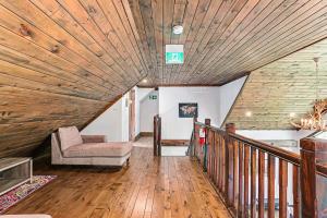 a living room with a wooden ceiling and a chair at Chalet at Blue in Blue Mountains +28 photos