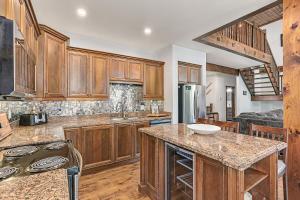 a kitchen with wooden cabinets and a counter top at Chalet at Blue in Blue Mountains