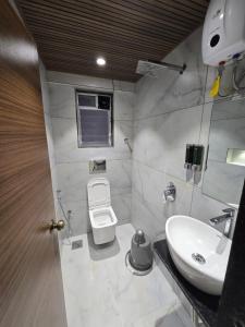 a bathroom with a sink and a toilet at Hill Top Stays in Navi Mumbai +18 photos