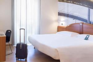 Ένα ή περισσότερα κρεβάτια σε δωμάτιο στο B&B Hotel Pescara