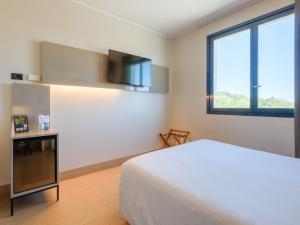a hotel room with a bed and a television at B&B Hotel Ravenna in Ravenna +22 photos