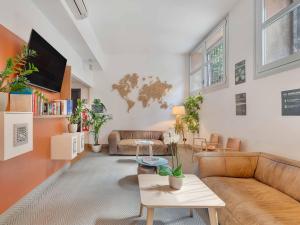 a living room with a couch and a table at B&B Hotel Milano Sant'Ambrogio in Milan
