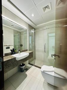 a bathroom with a sink and a toilet and a shower at Executive 1BR - Perfect for DIFC & Trade Center in Dubai