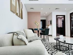 a living room with a couch and a table at Executive 1BR - Perfect for DIFC & Trade Center in Dubai +20 photos