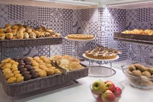 a bakery with many different types of pastries and pies at B&B Hotel Milano Cenisio Garibaldi in Milan