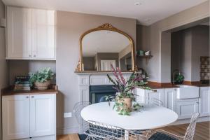 a kitchen with a white table and a mirror at Number 86 in Marlborough