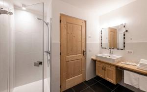 a bathroom with a shower and a sink and a mirror at Christlrumerhof in Brunico +30 photos