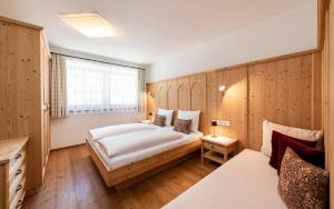 a bedroom with a large bed and a window at Christlrumerhof in Brunico