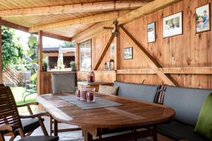 a wooden table with chairs and a wooden wall at Christlrumerhof in Brunico