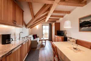 a kitchen with wooden cabinets and a table in a room at Christlrumerhof in Brunico