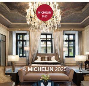 a master bedroom with a bed and a chandelier at H15 Palace, a Luxury Collection Hotel, Krakow in Kraków