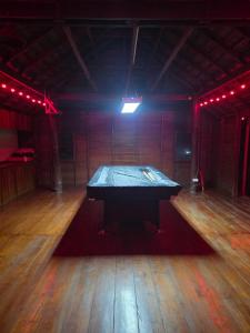 a ping pong table in the middle of a room at KNM Living Home in Pai