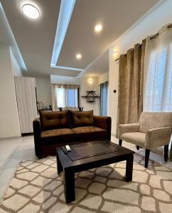 a living room with a couch and a coffee table at Appart'Hotels TEK & TEY in Dakar