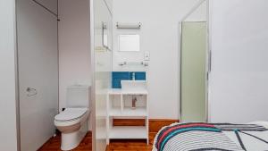 a bathroom with a toilet and a sink at Blossom Boutique Guesthouse in Muizenberg +24 photos