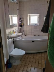 a bathroom with a tub and a toilet and a sink at Sunny ROOM in Stockholm in Stockholm +10 photos