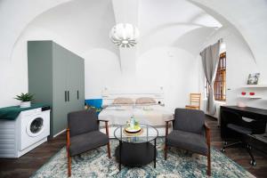 a bedroom with a bed and a table and chairs at Cute Apartment in the heart of Old Town in Košice