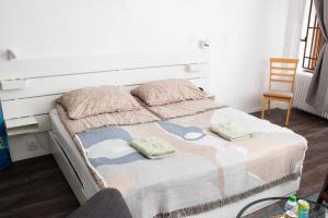 a bedroom with a bed with two pillows on it at Cute Apartment in the heart of Old Town in Košice