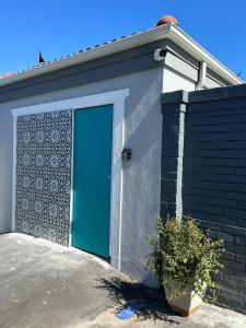 a blue door on the side of a house at Studio Seabiscuit in Cape Town