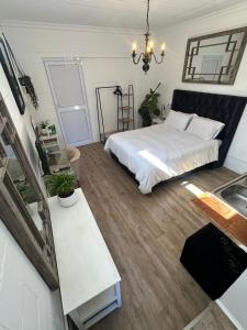 a bedroom with a bed and a sink in it at Studio Seabiscuit in Cape Town +8 photos