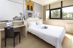 Ένα ή περισσότερα κρεβάτια σε δωμάτιο στο B&B Hotel Udine