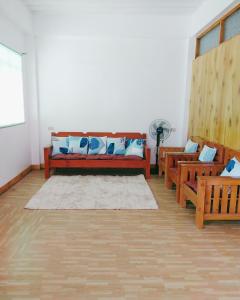 a living room with a couch and some chairs at Ag-agongan Lodge in Baguio