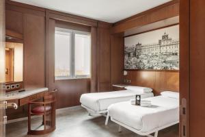 Ένα ή περισσότερα κρεβάτια σε δωμάτιο στο B&B Hotel Modena