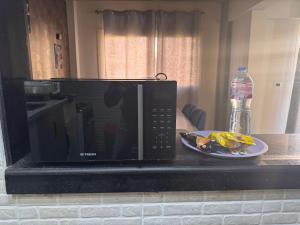 a microwave sitting on a counter with a plate of food at البيت بيتك الواحة in 6th Of October