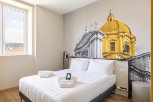 a bedroom with a large white bed with a yellow building at B&B Hotel Brescia in Brescia