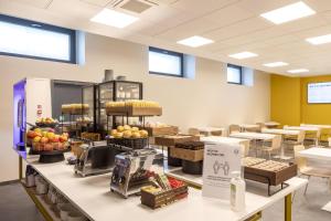 a store filled with lots of fruits and vegetables on display at B&B Hotel Brescia in Brescia +31 photos