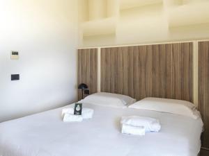 Ένα ή περισσότερα κρεβάτια σε δωμάτιο στο B&B HOTEL Pomezia Cortese