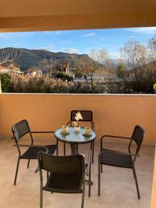 a table and chairs on a patio with a view at M&M Trebinje in Trebinje