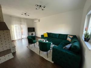 a living room with a green couch and chairs at M&M Trebinje in Trebinje