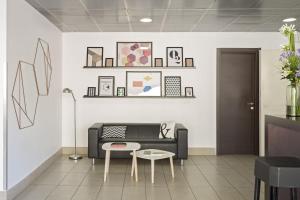 a living room with a couch and a table at B&B Hotel Firenze Nuovo Palazzo Di Giustizia in Florence