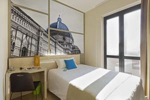 a bedroom with a bed and a picture of a building at B&B Hotel Firenze Nuovo Palazzo Di Giustizia in Florence +15 photos
