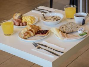 ein Frühstückstablett mit Frühstückszutaten auf dem Tisch in der Unterkunft B&B Hotel Firenze Novoli in Florenz