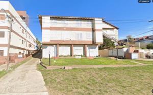 a large building with a grass yard in front of it at 143 Boutique in Villa Gesell