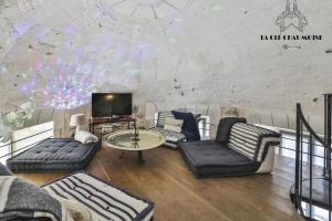 een woonkamer met banken en een tv bij Vivez dans cet ancien semaphore avec vue mer in Les Sables-dʼOlonne