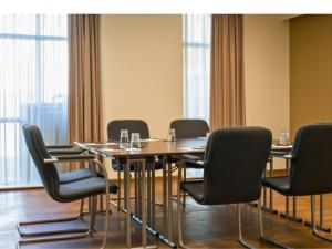 a conference room with a wooden table and chairs at B&B HOTEL Ipswich in Ipswich