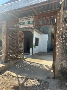 桑给巴尔Spice Garden Lodge B&B的带有标志的建筑物入口