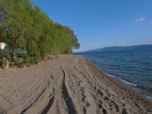 a dirt road next to a body of water at Maria's apt in Amarynthos