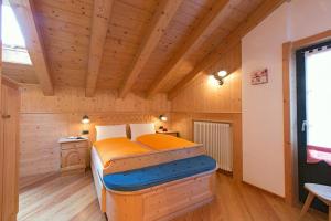 a bedroom with a bed in a wooden room at Art Apartments Kandinsky in Livigno