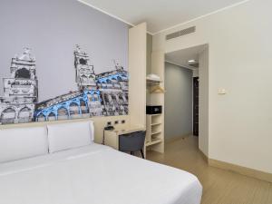 a bedroom with a bed and a drawing on the wall at B&B Hotel Milano-Monza in Monza