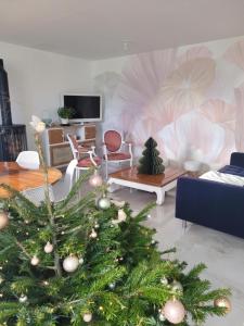 a living room with a christmas tree in the middle at Maison de Coton Ty Koton in Plourivo
