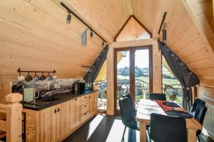 a kitchen and dining room with a table and a window at Bukowiańska Osada in Bukowina Tatrzańska