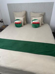 a bed with two pillows on top of it at Chez Aurore in Port-de-Bouc