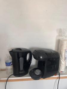 a coffee maker and a toaster sitting on a shelf at Tinchebray in Tinchebray