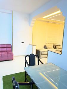 a room with a table and chairs and a couch at Dar diyafa kannoua in Tangier +4 photos