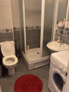 a bathroom with a toilet and a shower and a sink at SKY Apartments in Ohrid